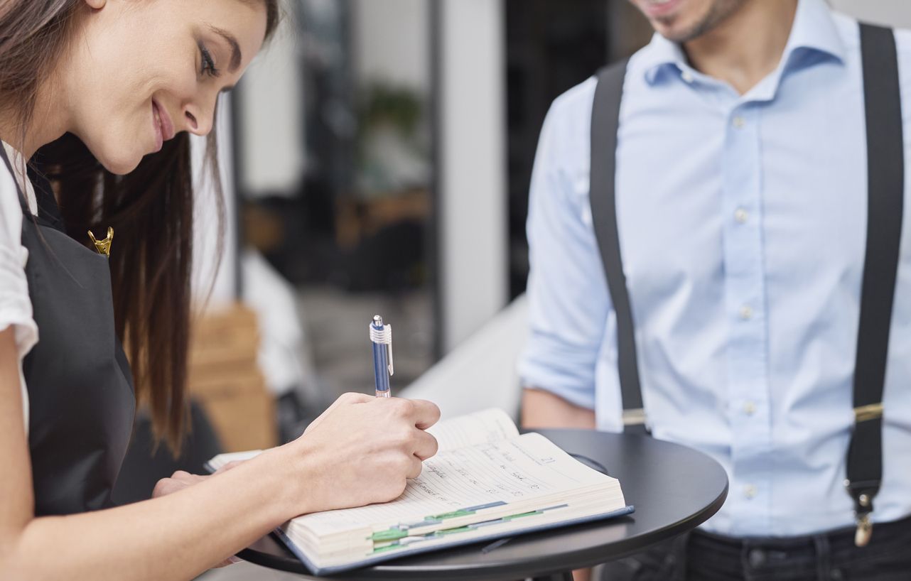 Open hotel guestbook with handwritten stories and memories from guests at Imagine Hospitality Nashville hotels