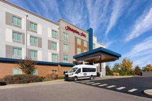 Hampton Inn Nashville Airport Century Place – Exterior View with Shuttle Access Exterior of Hampton Inn Nashville Airport Century Place with shuttle parking and hotel entrance