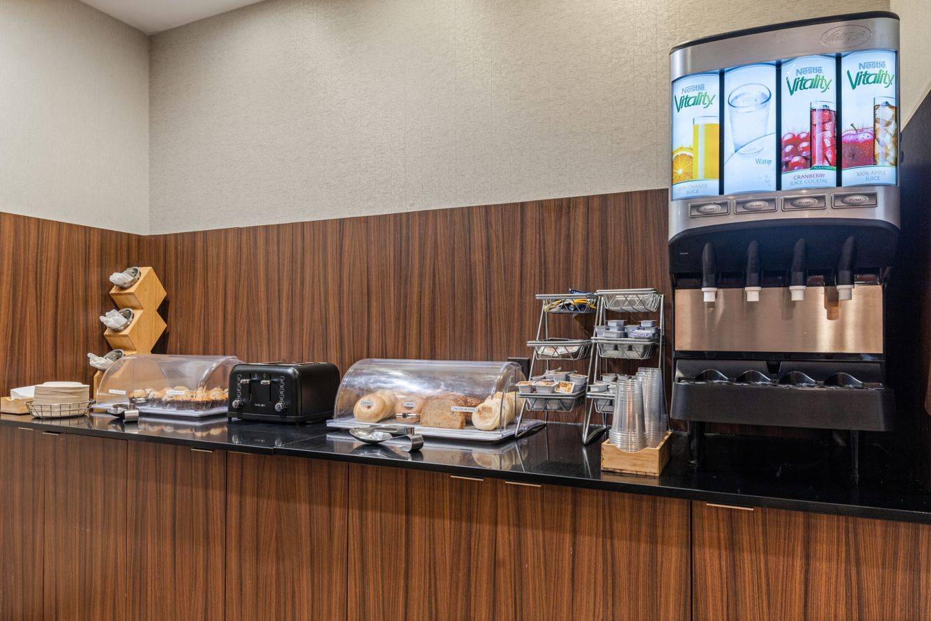 Complimentary breakfast area with coffee, pastries, bagels, and beverage station at Fairfield Inn & Suites Nashville MetroCenter