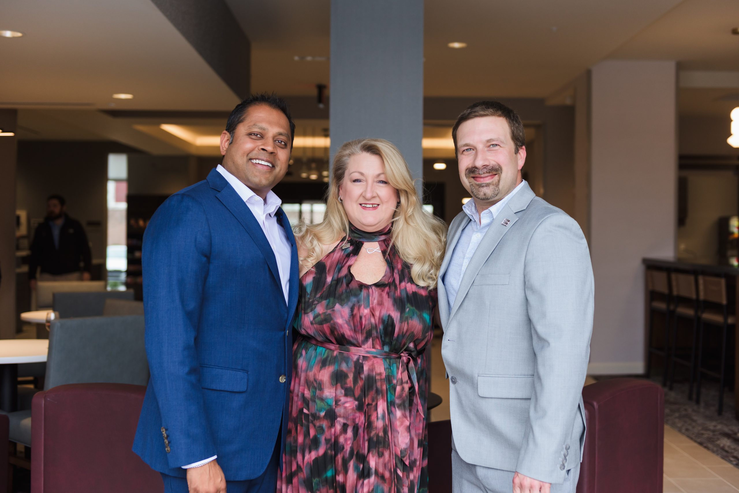 Imagine Hospitality CEO, head of operations and hotel general manager inside a hotel lobby